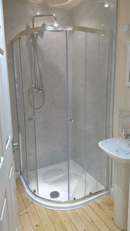 a shower stall in a bathroom with a sink at Craskie Glamping Pods in Inverness