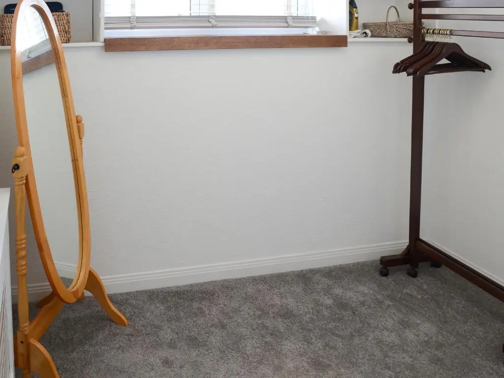 a room with a white wall and a window at Sea Thistle Cottage in Nairn