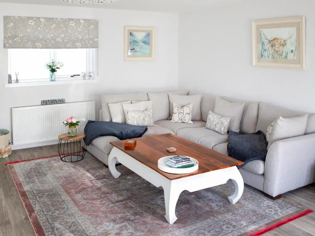 a living room with a couch and a coffee table at Rose Cottage in Dingwall