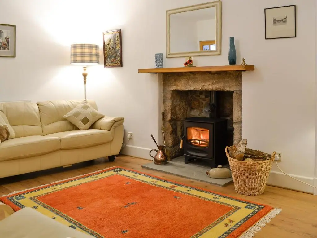 a living room with a couch and a fireplace at Craigclunie in Ballater