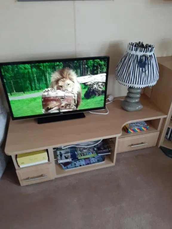a flat screen tv sitting on top of a desk at Taid's Retreat Silversands Cove beach lossiemouth in Lossiemouth