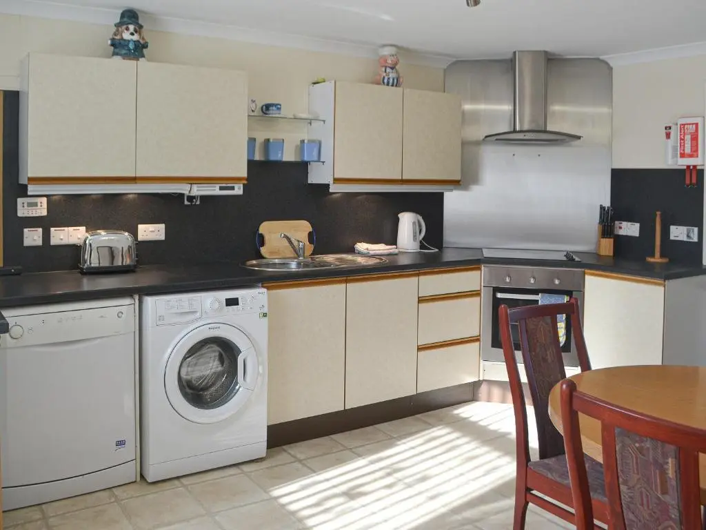 a kitchen with a washing machine and a washer at Dolphin View - Uk30689 in Portknockie