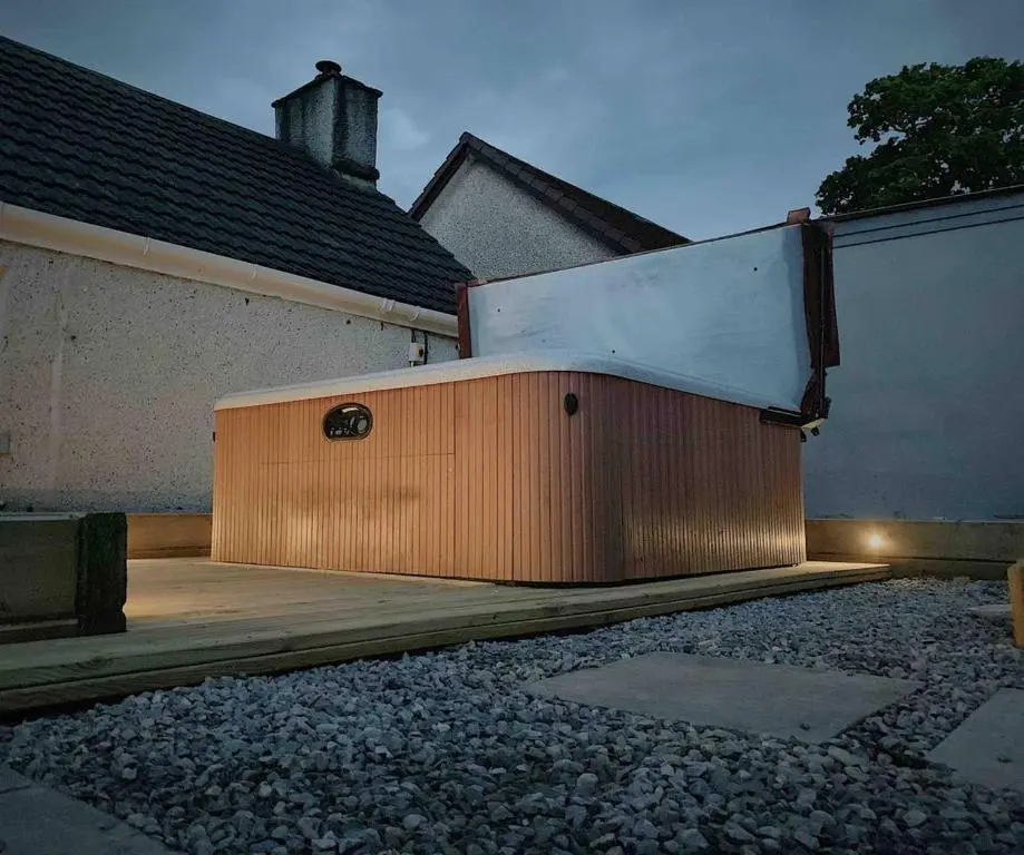 a building with a door on the side of a house at Highland HotTub Retreat, on NC500 in Inverness
