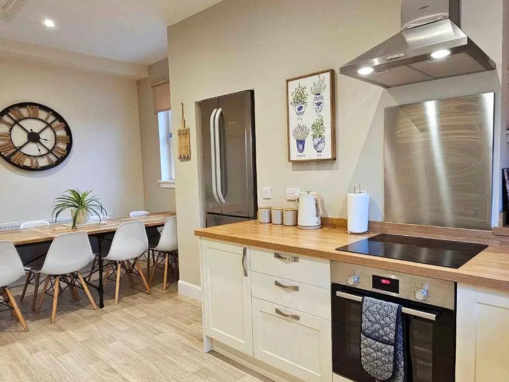 a kitchen with a sink and a counter top at Balmore Farmhouse in Lochend