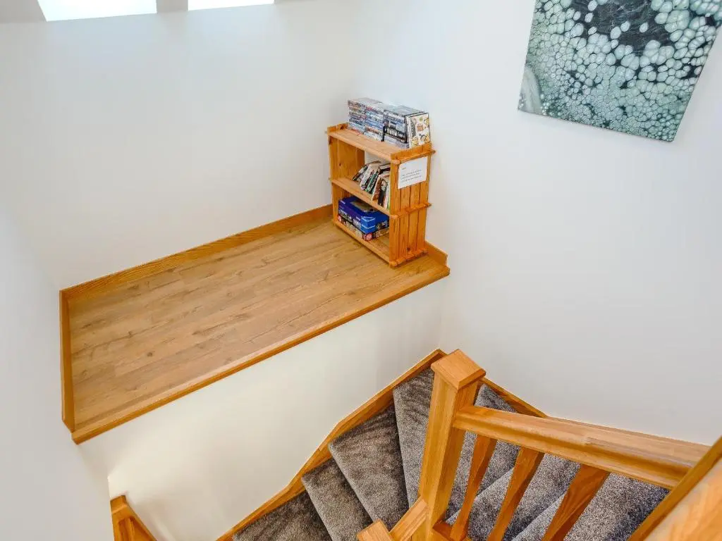 a stairwell with a wooden rail and a stair case at Auld Kirk Hall in Kirktown of Auchterless