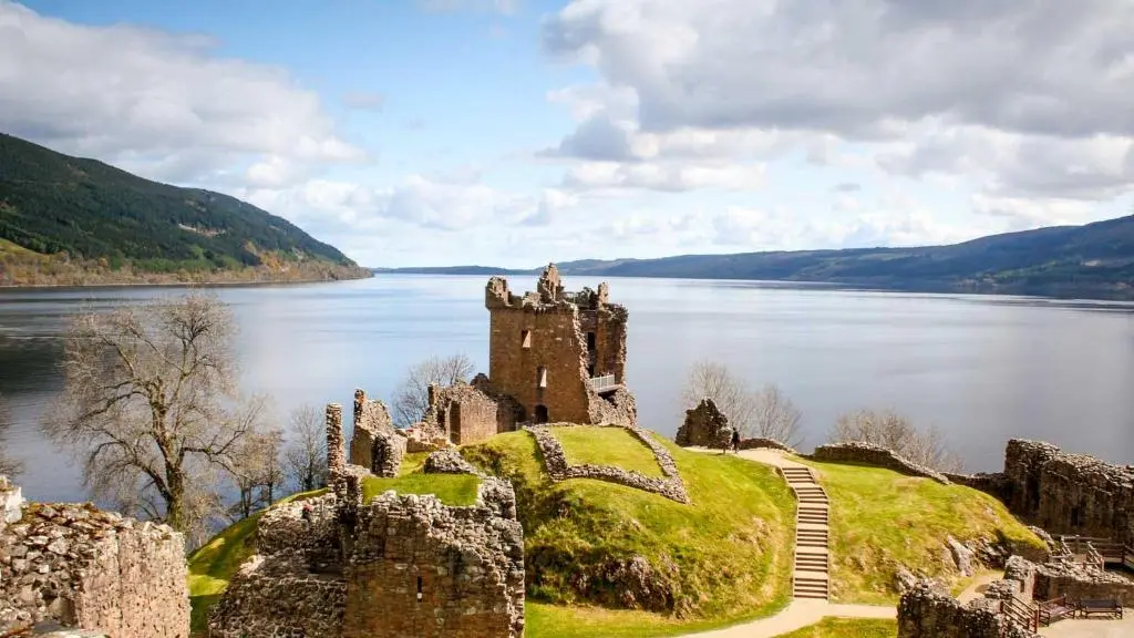 a castle on a hill next to a body of water at Inverness Holiday Retreat - 2 Bedroom in Inverness