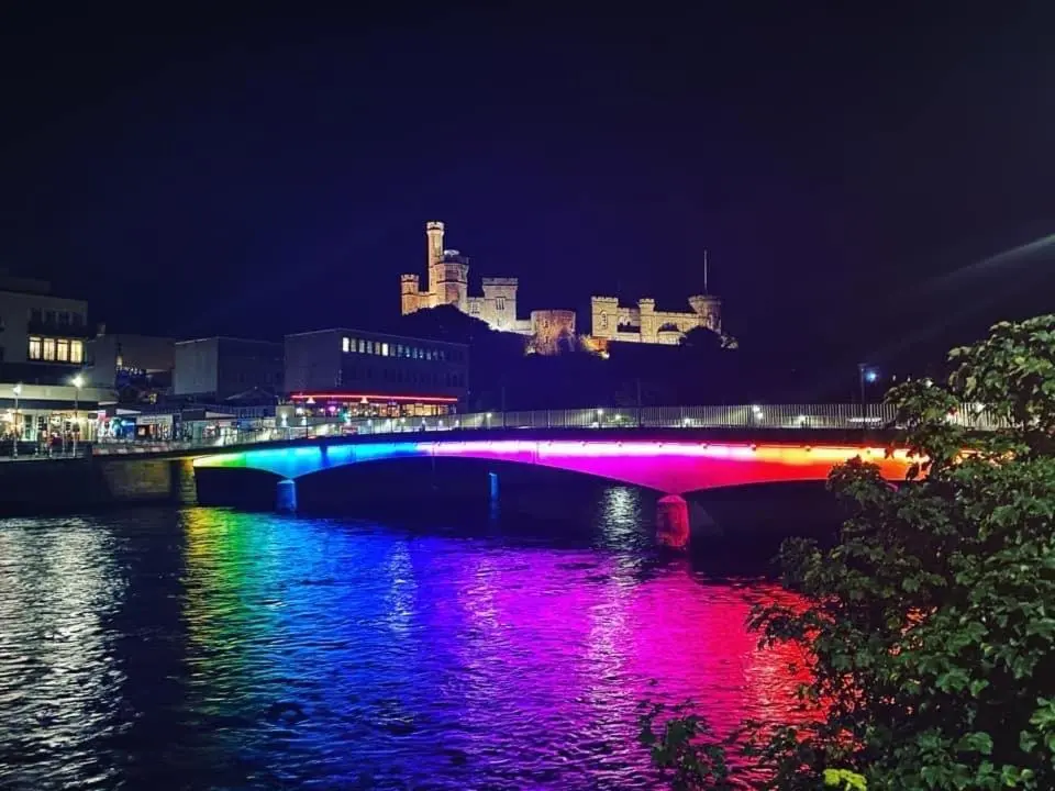 a bridge with colorful lights on the water at night at Inverness Holiday Retreat - 2 Bedroom in Inverness