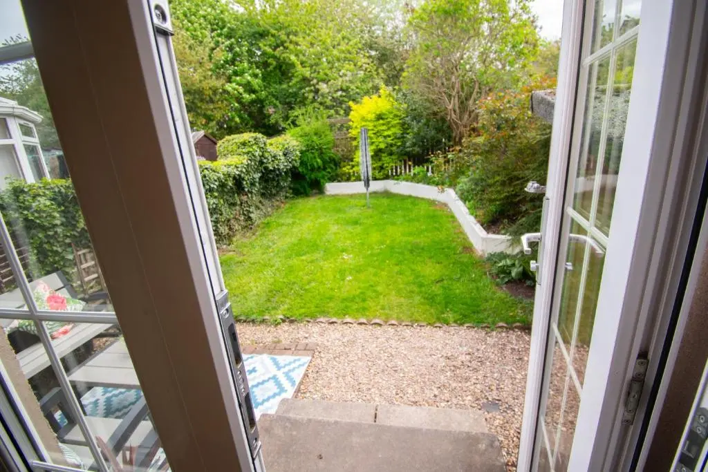 a view of a yard from a sliding glass door at Inverness Holiday Retreat - 2 Bedroom in Inverness
