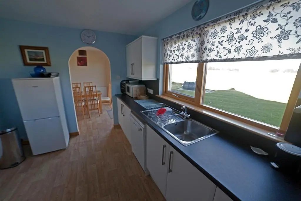 a kitchen with a sink and a large window at Ard Garraidh in Ardersier