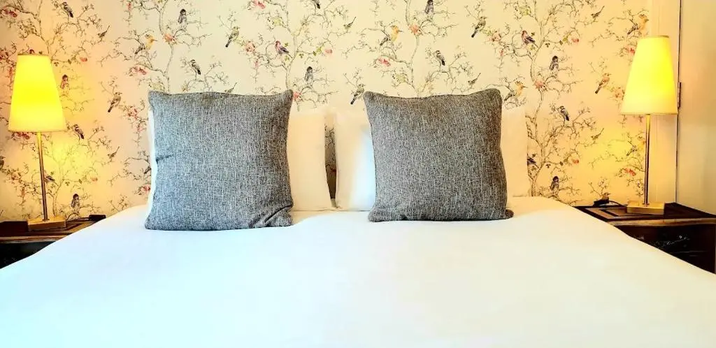 a bed with two pillows on top of it at The Osprey Hotel in Kingussie