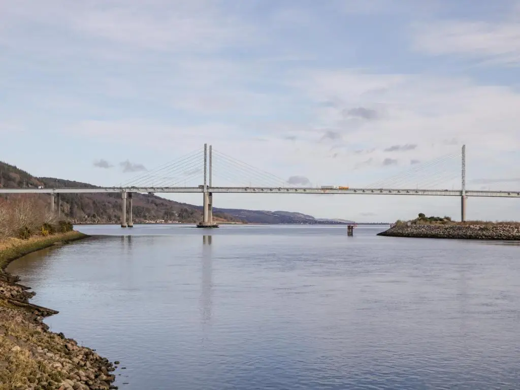 a bridge over a river with a bridge in the background at Riverview Apartment in Inverness