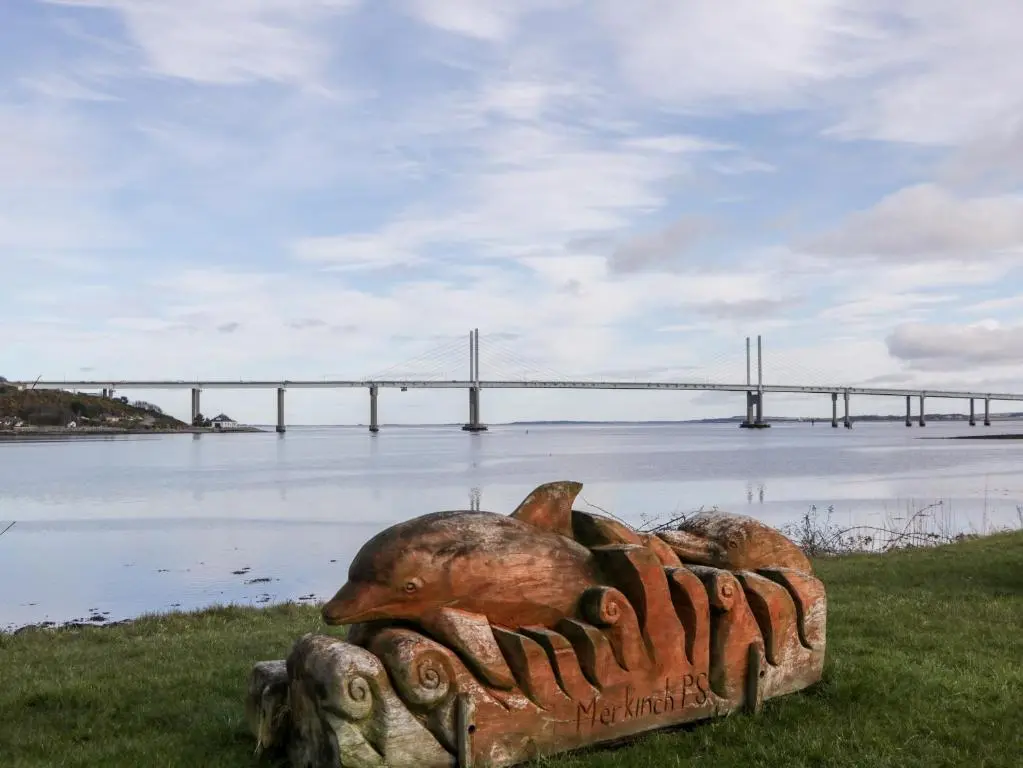 a statue of a fish with a bridge in the background at Riverview Apartment in Inverness