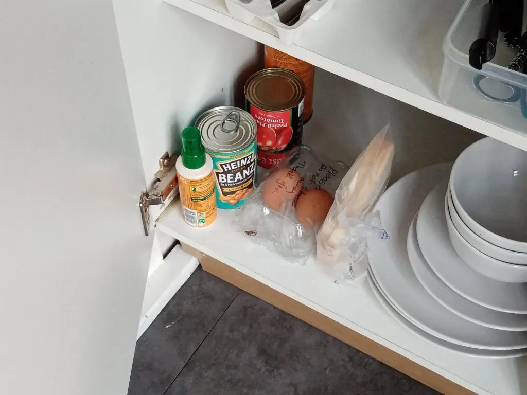 an open refrigerator with food and spices on a shelf at Wee Hoose Glamping Pod 1 in Skail