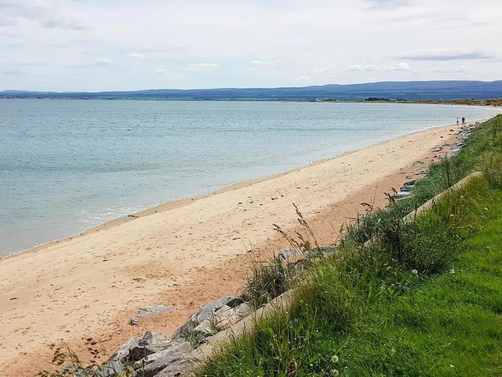 a sandy beach with the ocean in the background at The Dolphin - Uk31004 in Avoch