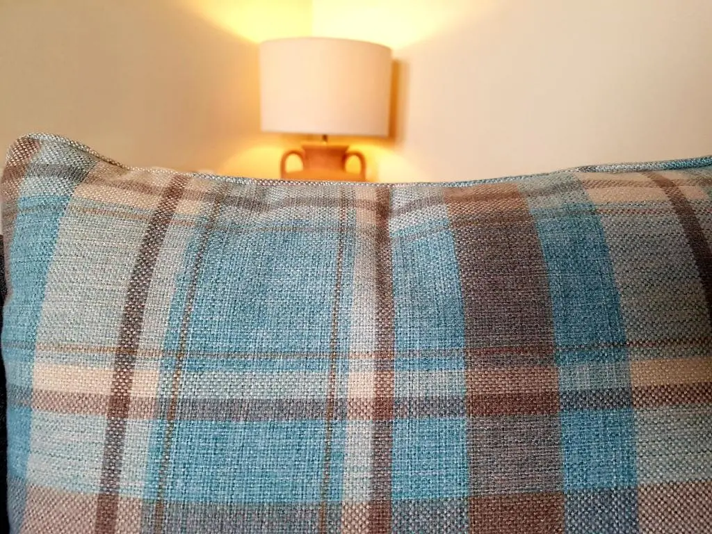 a close up of the back of a couch with a lamp at Caledonian 2 bedroom free parking in Inverness