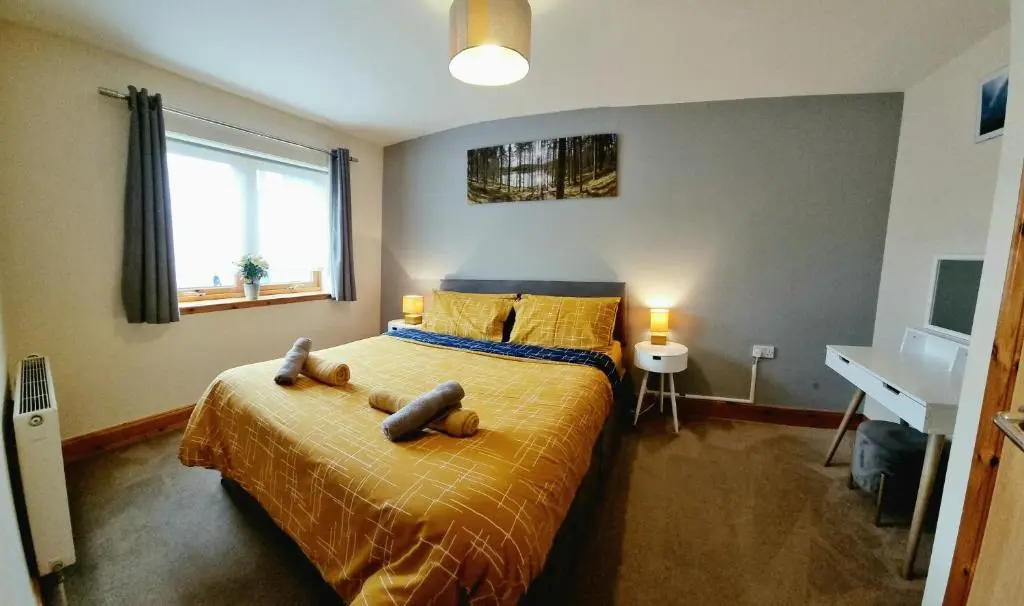 a bedroom with a bed with two stuffed animals on it at Caledonian 2 bedroom free parking in Inverness