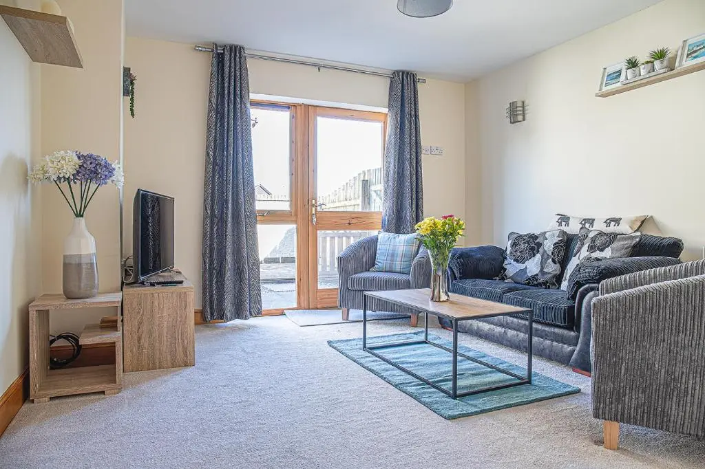 a living room with a couch and a tv at Caledonian 2 bedroom free parking in Inverness