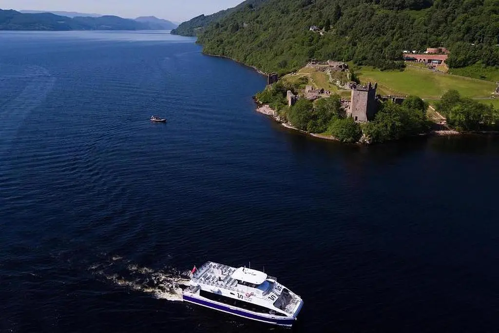 a cruise ship in a large body of water at Inverness City 2 bedroom free parking in Inverness