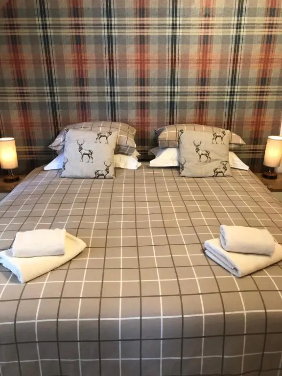 a large bed in a room with two pillows at Thistle Apartment, Inverness in Inverness