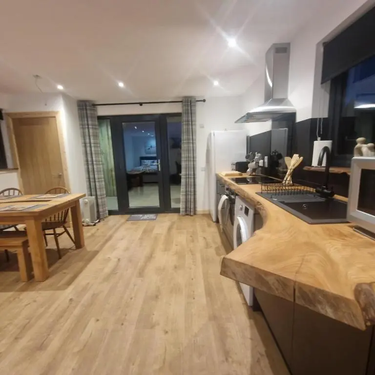a kitchen with a table and a counter top at Pleasant Point Holiday Cottages in Rosemarkie