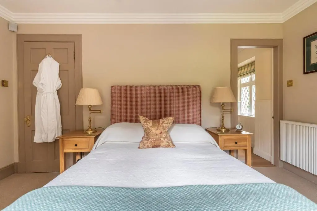 a bedroom with a large bed and two night stands at Balnagown Estates Swiss Cottage in Barbaraville