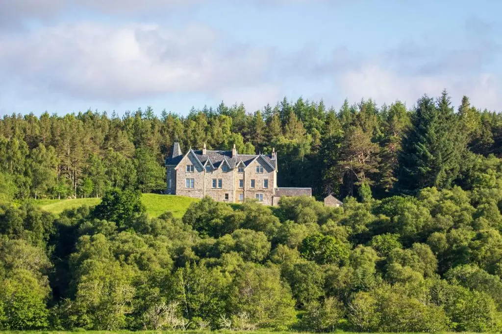 an old house on a hill in the forest at Inveroykel Lodge at Rosehall in Rosehall