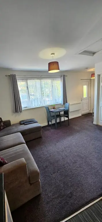 a living room with a couch and a table at Arisaig Flat in Inverness