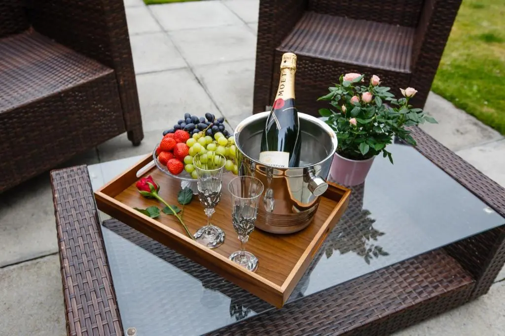 a tray with a bottle of champagne and fruit on a table at St Andrews House in Ballater
