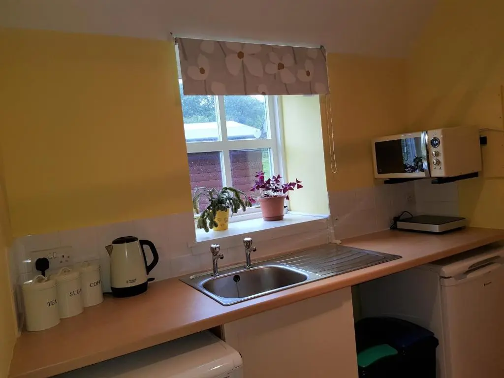 a kitchen counter with a sink and a window at Jakels Rest in Lairg