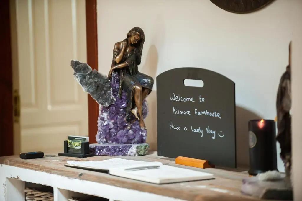 a statue of a woman sitting on top of a table at Kilmore Farmhouse in Drumnadrochit
