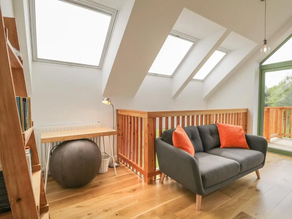 a living room with a couch and two skylights at Na Clamhanan in Forres