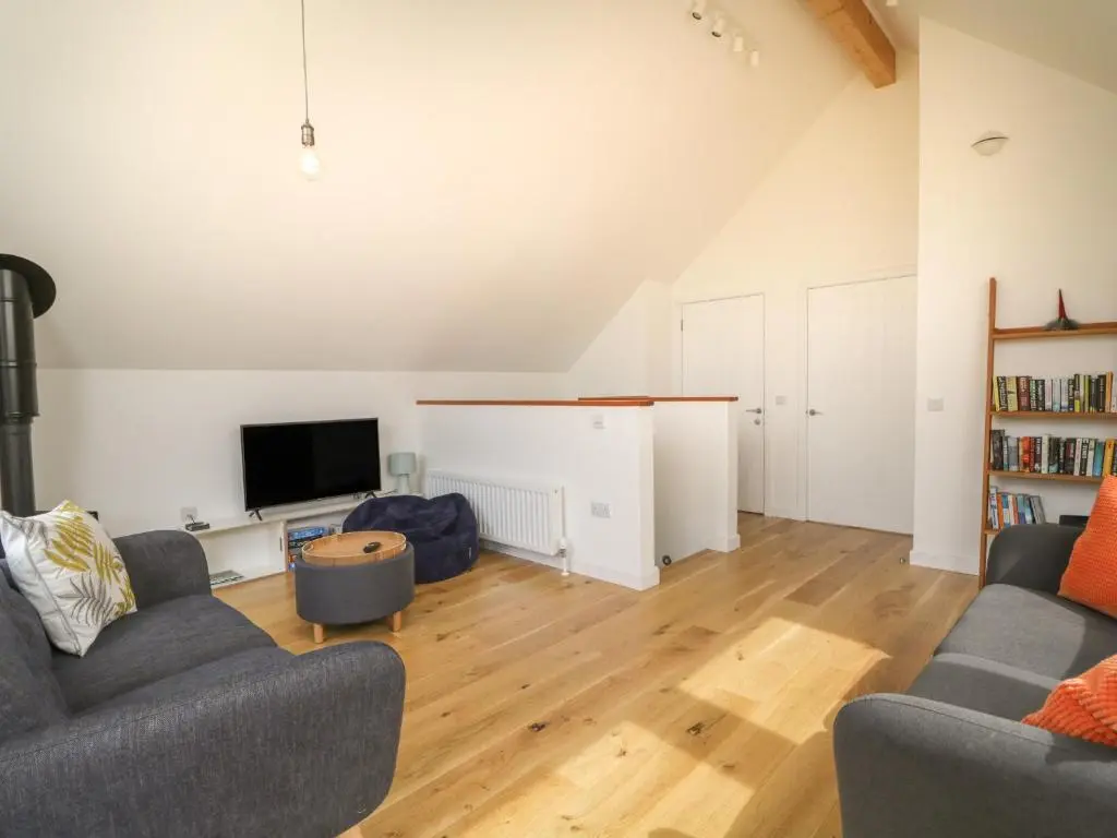 a living room with two couches and a tv at Na Clamhanan in Forres
