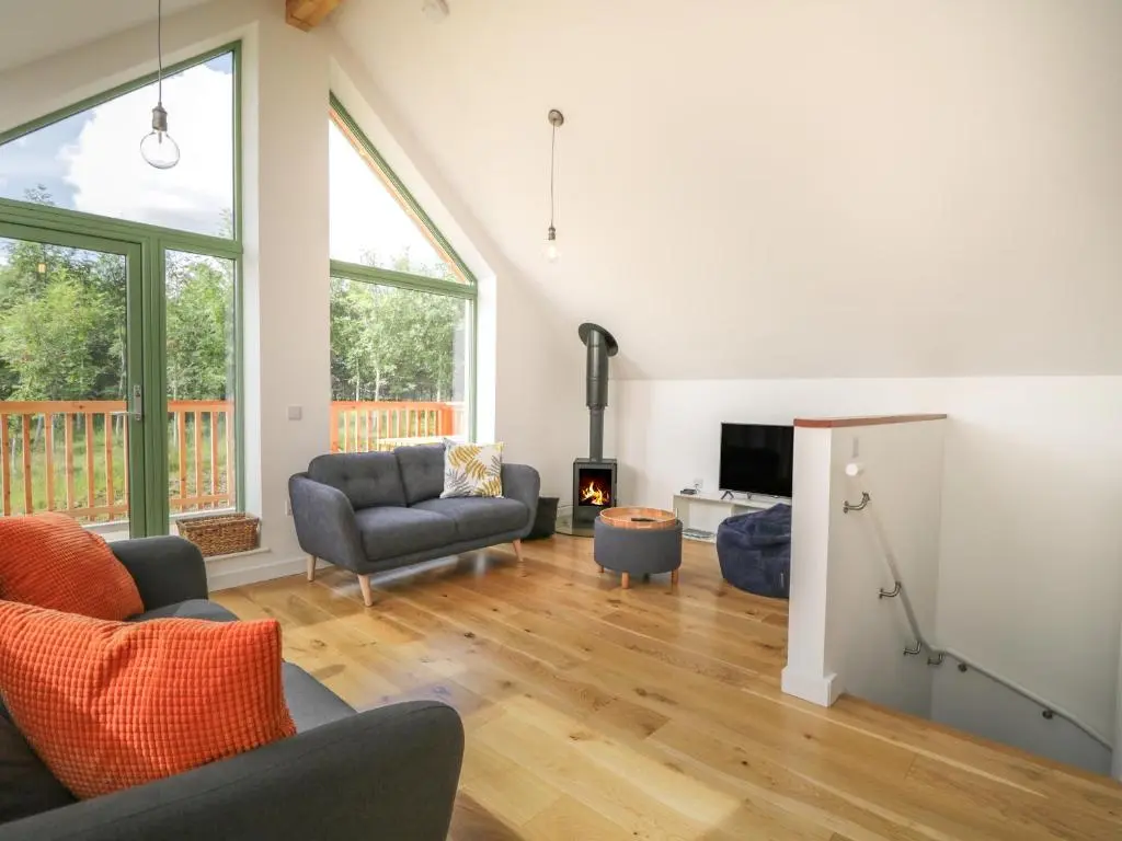 a living room with a couch and chairs and a fireplace at Na Clamhanan in Forres