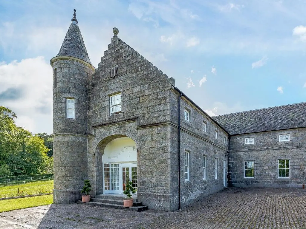 an old stone building with a large entrance at Skene House Court in Dunecht