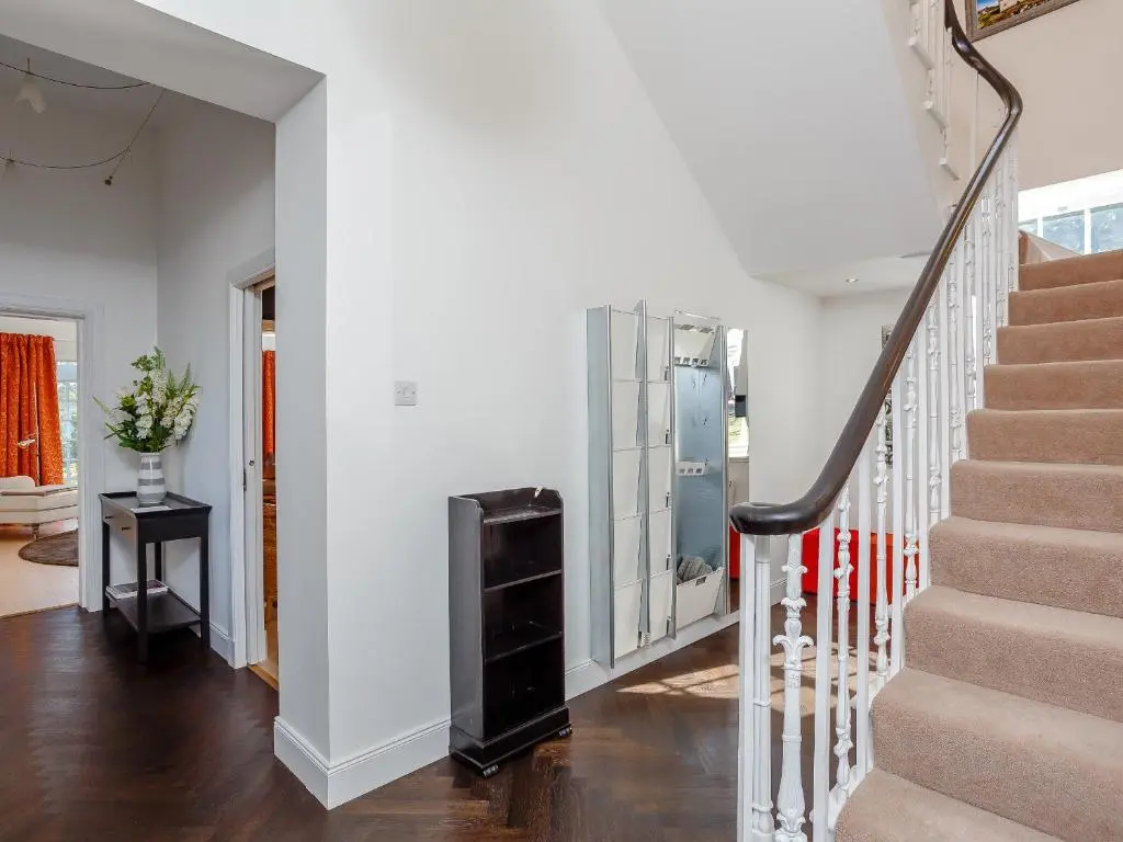 a staircase in a home with white walls at Skene House Court in Dunecht