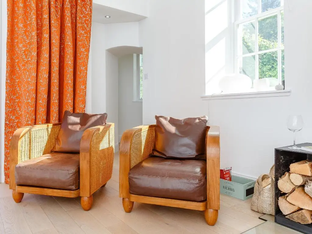 two chairs sitting in a living room next to a window at Skene House Court in Dunecht