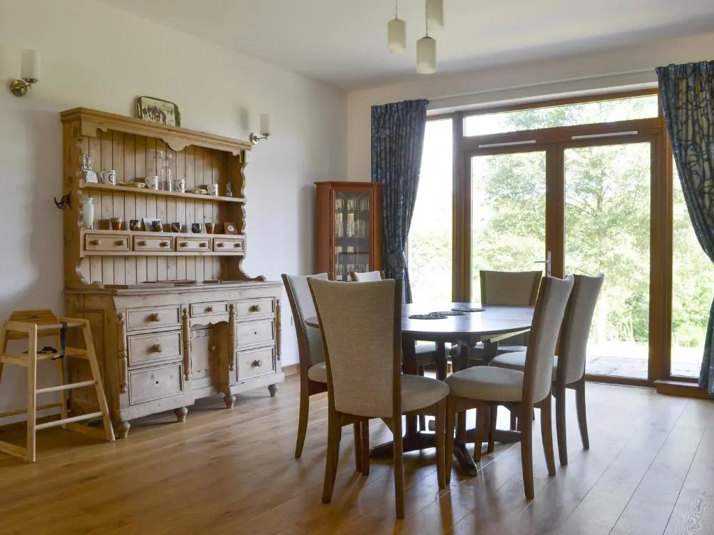 a dining room with a table and chairs at Battanropie Lodge in Carrbridge