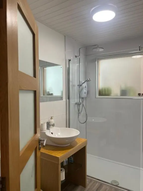 a bathroom with a sink and a shower at Shamerbrea The Foodie B&B in Inverness