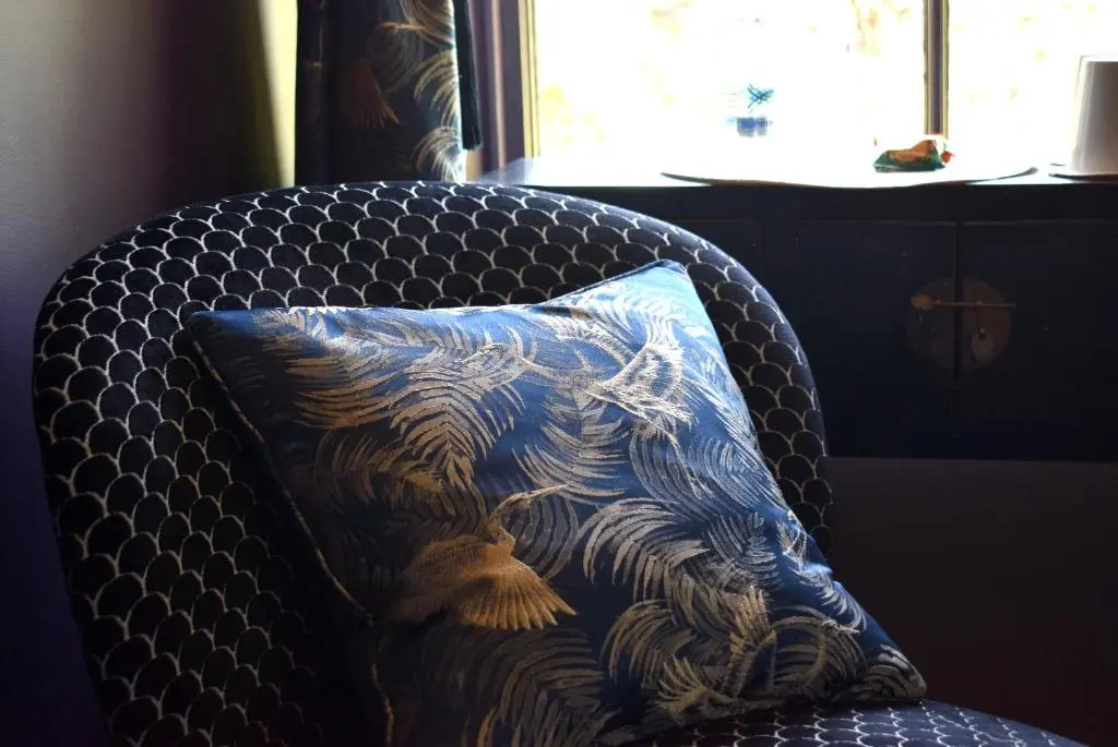a pillow sitting on a chair in a room at The Mash Tun in Aberlour