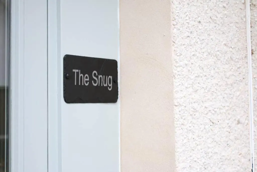 a sign that reads the snug on a door at The Snug at the Ski Lodge, Aviemore in Aviemore