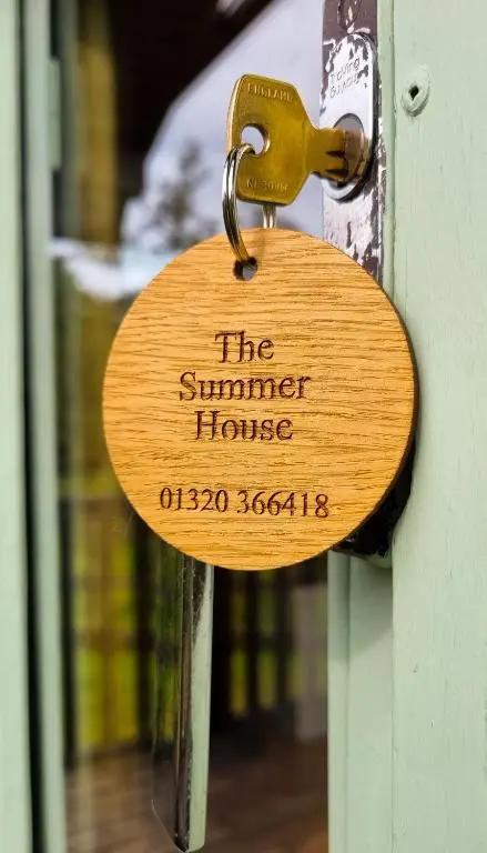 a lock on a door with the summer house on it at Cabins at Old Pier House in Fort Augustus