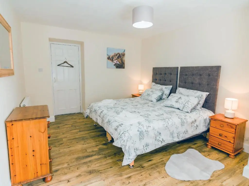 a bedroom with a bed and a wooden floor at Keepers Cottage - Uk30246 in Cray