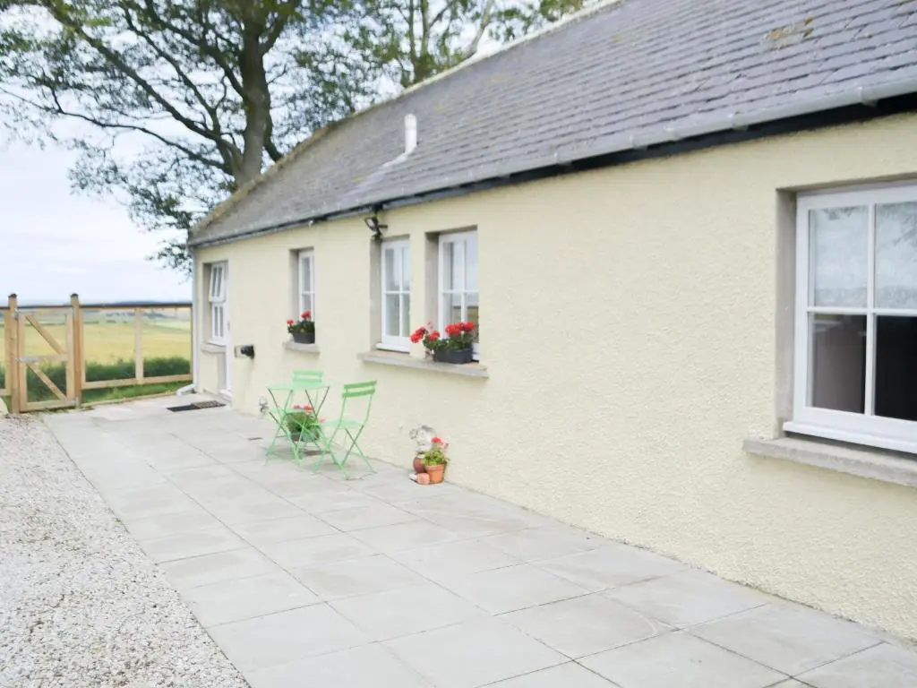 a patio outside of a house with a building at Mansefield Cottage in Boyndie
