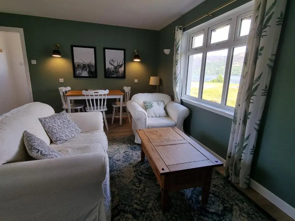 a living room with a couch and chairs and a table at The Apartment at Old Pier House in Fort Augustus