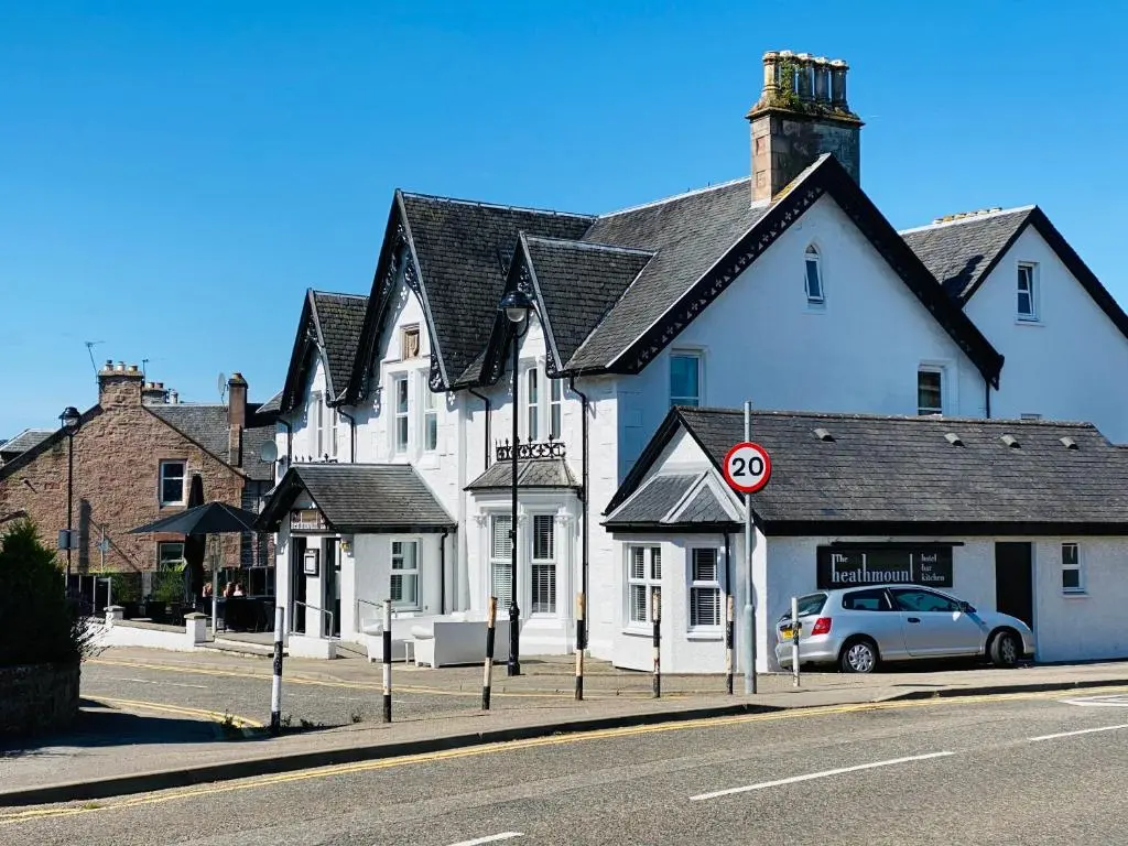 a large white building on the side of a street at Castle Grant Apartment in Inverness