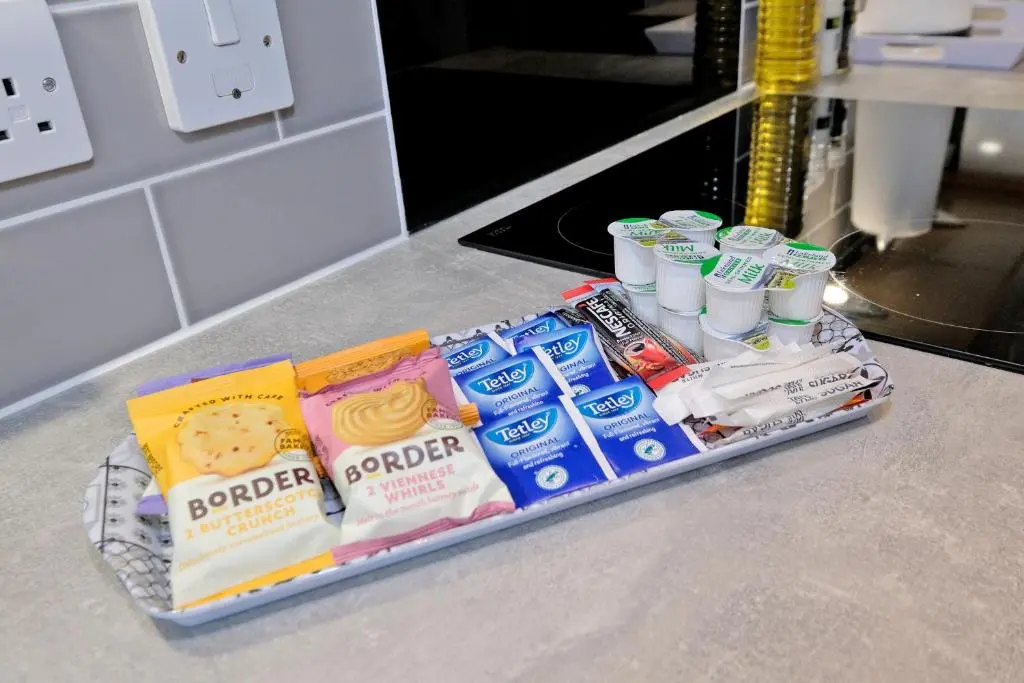 a tray of toothbrushes and toothpaste on a counter at Caledonia Newhills Apartment in Aberdeen