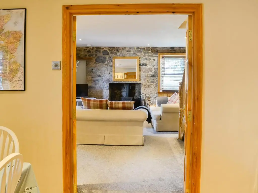 a living room with a couch and a fireplace at East Lewiston in Drumnadrochit