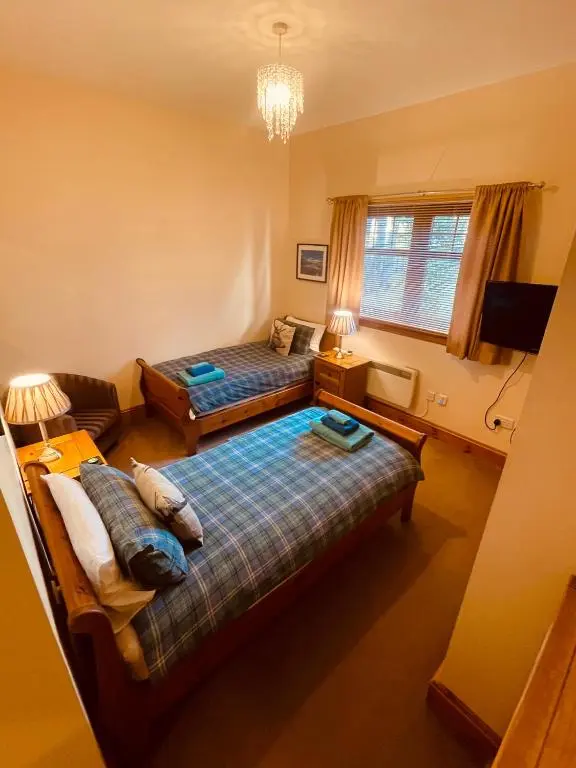 a living room with two beds and a couch at Dalmore in Nairn