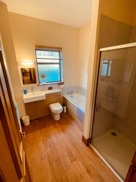 a bathroom with a toilet and a sink and a tub at Dalmore in Nairn