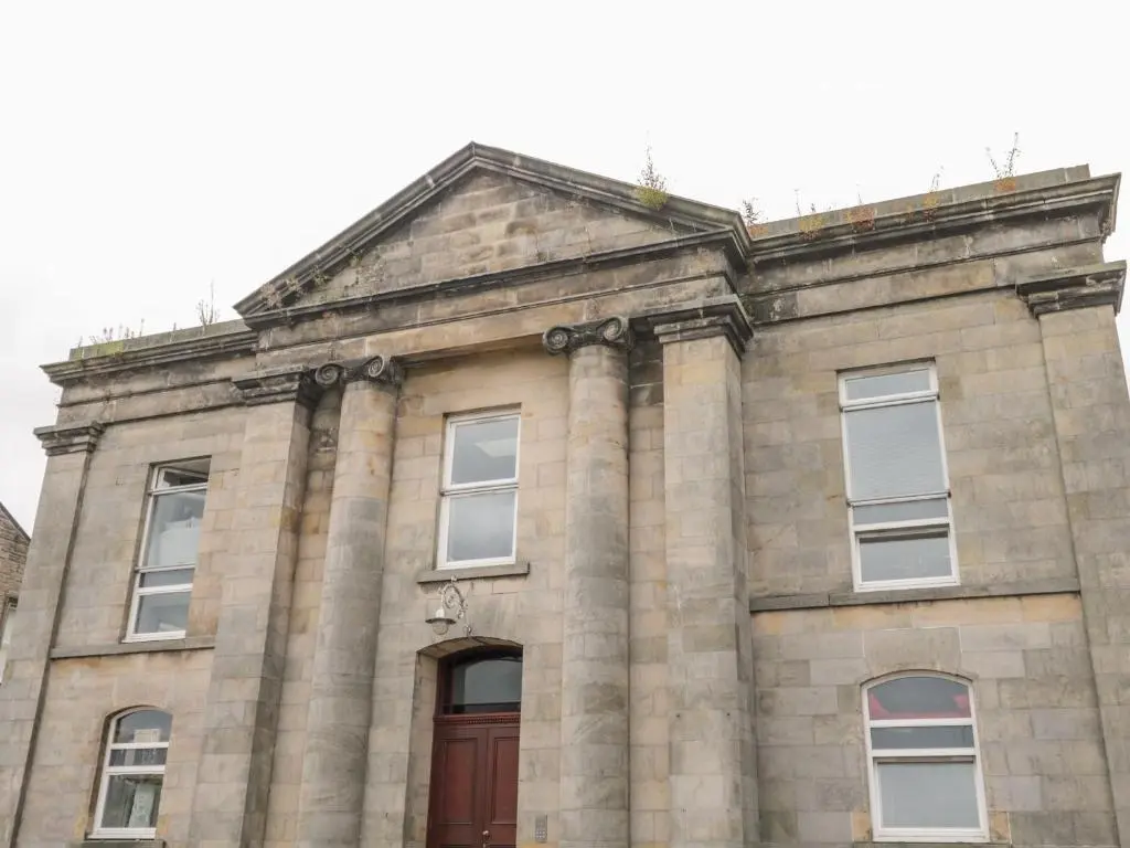 an old stone building with a red door at The Bell Tower in Inverness